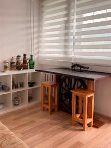 a table with two stools in a room at Mieszkanie Pod Sztolniami- Riese in Walim +10 photos