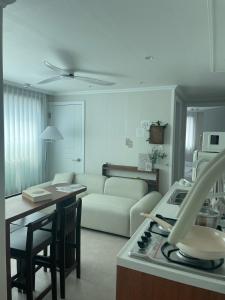 a kitchen and living room with a couch and a table at Daejeon Motto stay in Daejeon