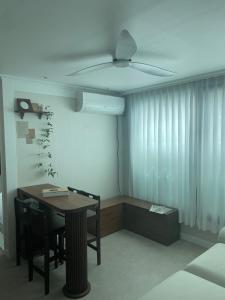 a room with a table and a ceiling fan at Daejeon Motto stay in Daejeon