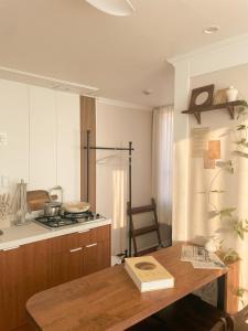 a kitchen with a wooden table and a stove at Daejeon Motto stay in Daejeon +31 photos