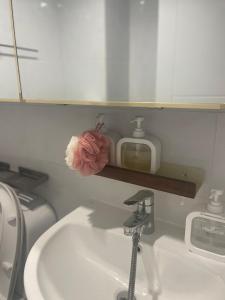 a bathroom sink with a faucet and a mirror at Daejeon Motto stay in Daejeon