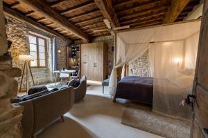 a bedroom with a bed and a table and chairs at Domaine de Gressac in Verfeuil +89 photos