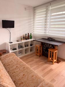 a living room with a table and a bed at Mieszkanie Pod Sztolniami- Riese in Walim