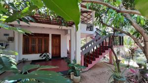 a house with a staircase leading to the front door at The Green Heritance in Habarana +15 photos