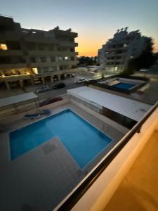 a swimming pool on the roof of a building at Lux Family Suite & Pool in Larnaca
