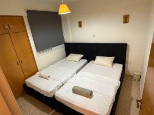 two beds in a small room with at Lux Family Suite & Pool in Larnaca
