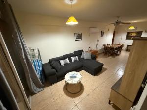 a living room with a couch and a table at Lux Family Suite & Pool in Larnaca