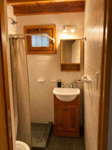 a small bathroom with a sink and a shower at Destino Patagonia in Esquel
