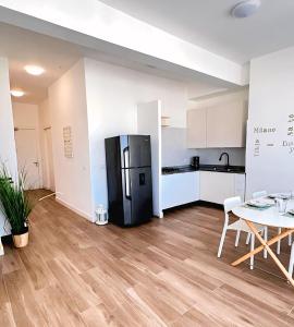 a kitchen with a black refrigerator and a table at Beach Veranda Hotel Punta Cana in Punta Cana +46 photos