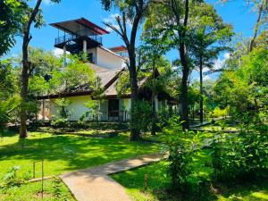 a house in the middle of a green yard at Victory Villa Sigiriya in Sigiriya