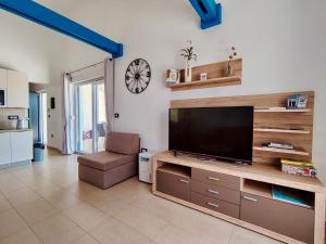 a living room with a flat screen tv on a entertainment center at Villa Alba in Vodnjan