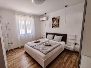 a bedroom with a large white bed with wooden floors at Villa Alba in Vodnjan +20 photos