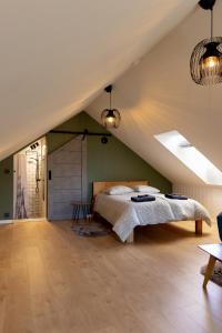 a bedroom with a bed in a attic at Lendle Peace & Wellness Stay Märjamaa in Märjamaa
