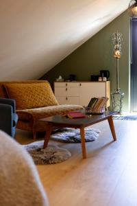 a living room with a couch and a coffee table at Lendle Peace & Wellness Stay Märjamaa in Märjamaa