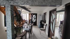 a dining room with a table and chairs at Casa samo in Vama Veche