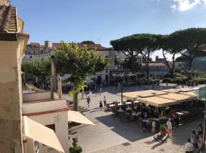 a group of people walking around a street with tables at Giardini Calce - Luxury Rooms in Ravello