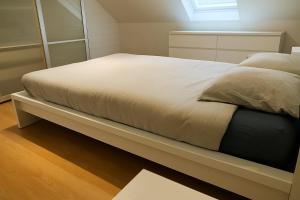 a bed sitting on a shelf in a bedroom at Cozy duplex apartment with free parking in Leuven