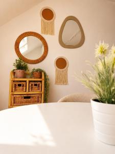 a room with mirrors on the wall and a table at Cozy duplex apartment with free parking in Leuven +1 photo