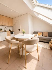 a living room with a white table and chairs at Cozy duplex apartment with free parking in Leuven
