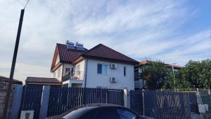 a white house with a fence in front of it at Casa samo in Vama Veche +5 photos