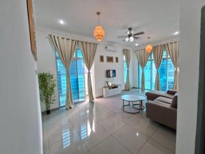 a living room with a couch and a table at D'Biru Homestay Segamat in Segamat