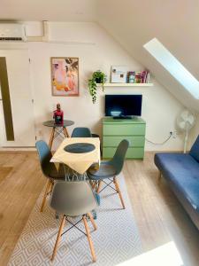 a living room with a table and chairs and a couch at Apartmány Lednice in Lednice