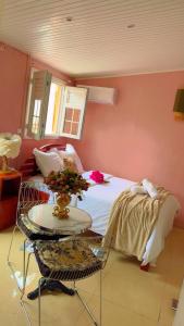 a bedroom with a bed and a table with a table sidx sidx sidx at Kay Lili in Rivière-Pilote