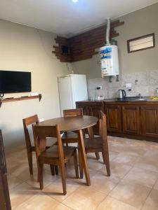 a kitchen with a table and chairs and a refrigerator at La moora in Alta Gracia