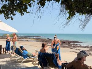 a group of people sitting in chairs on the beach at Anchaca Sul in Bubaque +22 photos
