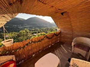 a wooden balcony with a view of a mountain at Natural House in Visoko +21 photos
