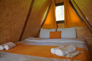 a bed in a tent with towels on it at GLAMPING WOLF MOUNt in Margahovit +38 photos