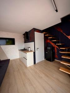 a room with a kitchen and a staircase in a house at ArtMi in Lazeshchyna +20 photos
