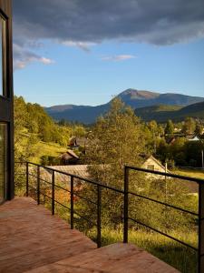 a balcony of a house with a view of the mountains at ArtMi in Lazeshchyna