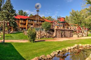 a playground in front of a house with a water park at Meadowbrook Resort in Wisconsin Dells
