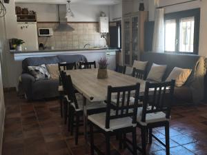 a table and chairs in a living room with a couch at Casa Rural Prado Alto,Foz Calanda in Foz-Calanda