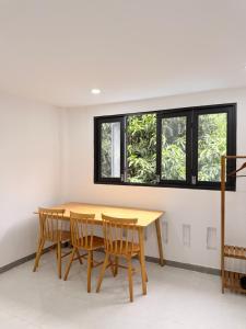 a dining room with a wooden table and chairs at Mango Villa Long Hải Beach in Long Hai