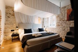 a bedroom with a large bed in a room at Murum Heritage Hotel in Split +38 photos