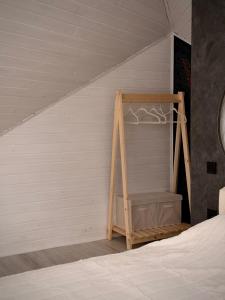 a bedroom with a bed with a wooden shelf at ArtMi in Lazeshchyna