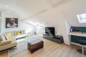 a living room with a couch and a fireplace at Monte Carlo Monaco Border - luxury, modern, cozy with home feelings and See View in Beausoleil