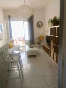 a living room with a couch and a table at Appartement Canet in Canet-en-Roussillon