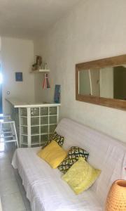 a bed with two pillows on it in a room at Appartement Canet in Canet-en-Roussillon