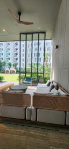 a living room with a couch and a ceiling fan at 4BR Beachfront Pantai Cenang Langkawi in Pantai Cenang