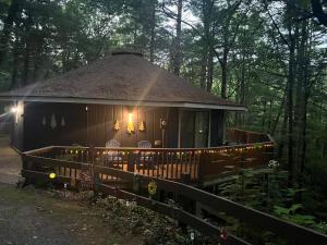 a cabin in the woods with a fence and lights at Sky Valley Casa Dolce Vita in Sky Valley
