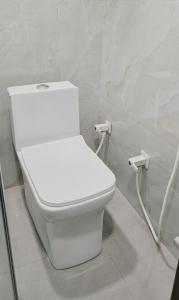 a bathroom with a white toilet in a room at Grey Courtyard Entire Studio Taj Mahal Parking 3KM in Agra