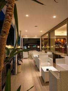a restaurant with white tables and white chairs at Hotel Columbia Frontemare in Rimini +22 photos