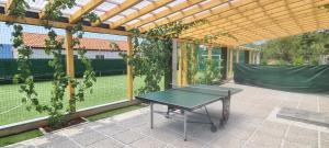 a ping pong table on a patio with a tennis court at Luxury White Sails Villas with a Multi Sport Court and Sea View in Pinezici +127 photos