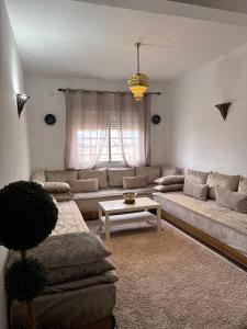 a living room with a couch and a table at Fès comfort stay in Fez +16 photos