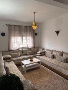 a living room with a couch and a table at Fès comfort stay in Fez