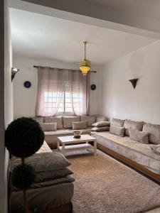 a living room with a couch and a table at Fès comfort stay in Fez