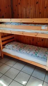 two wooden bunk beds in a wooden room at Chalet Saint Julien en Born in Saint-Julien-en-Born +19 photos